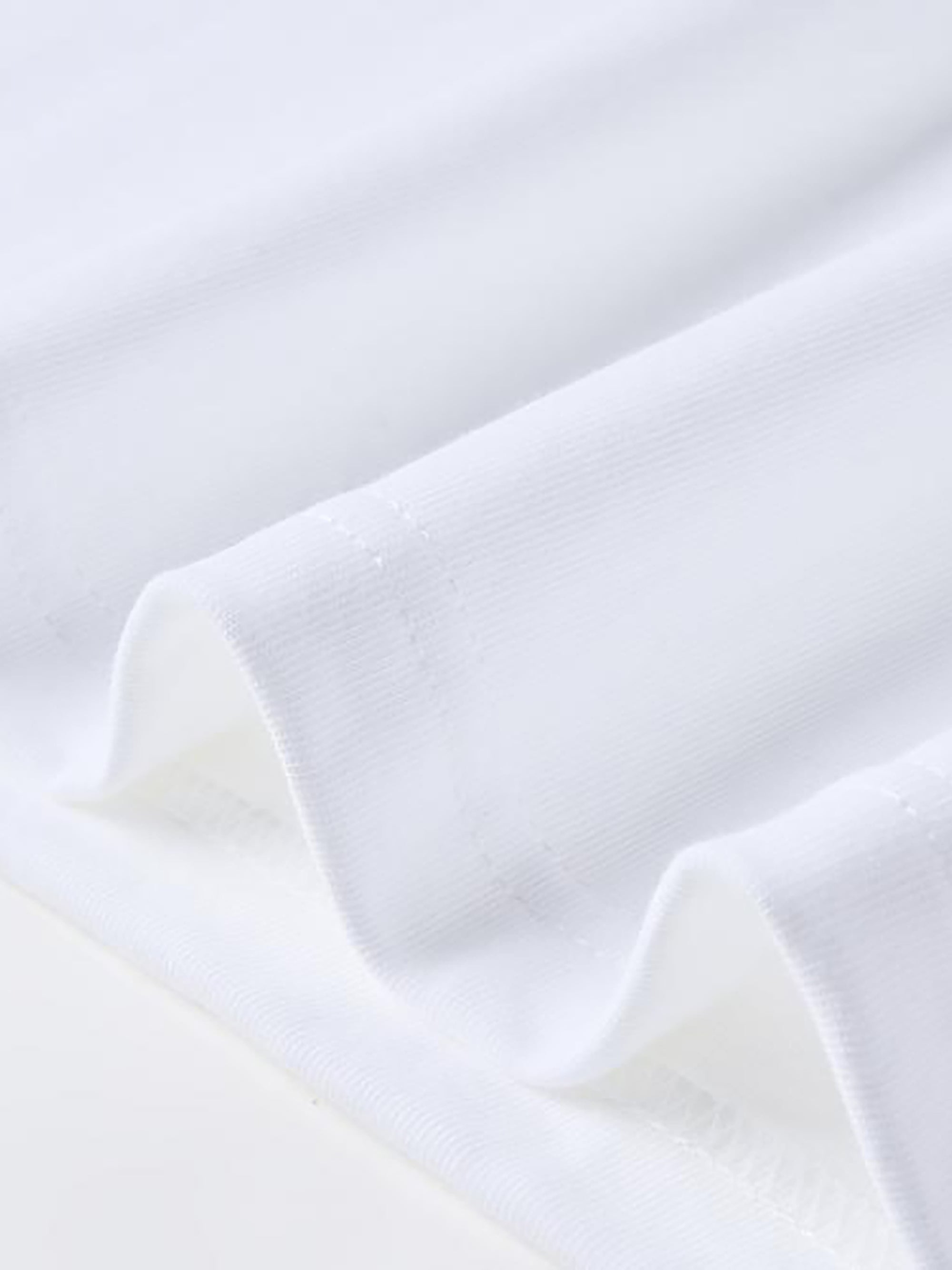 Soft white cotton fabric close-up showing smooth texture.