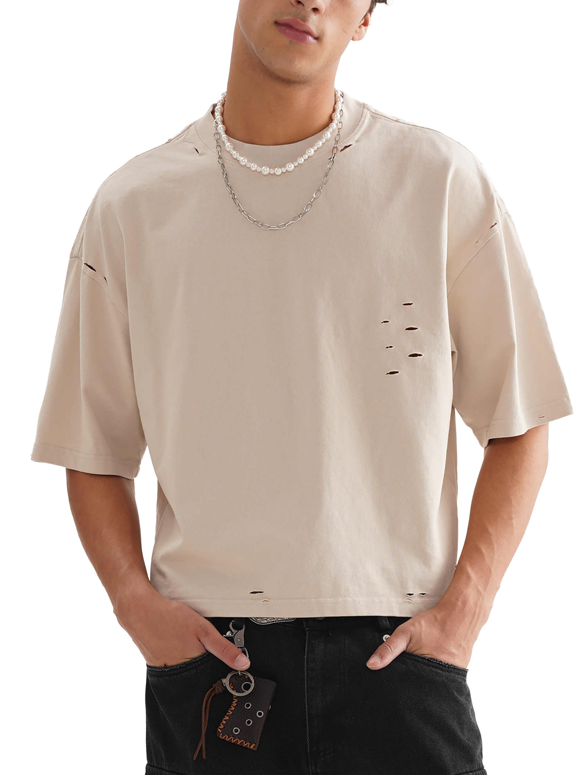 Male model wearing cream Genzerz distressed oversized tee with ripped detailing and relaxed streetwear fit — effortless and premium.