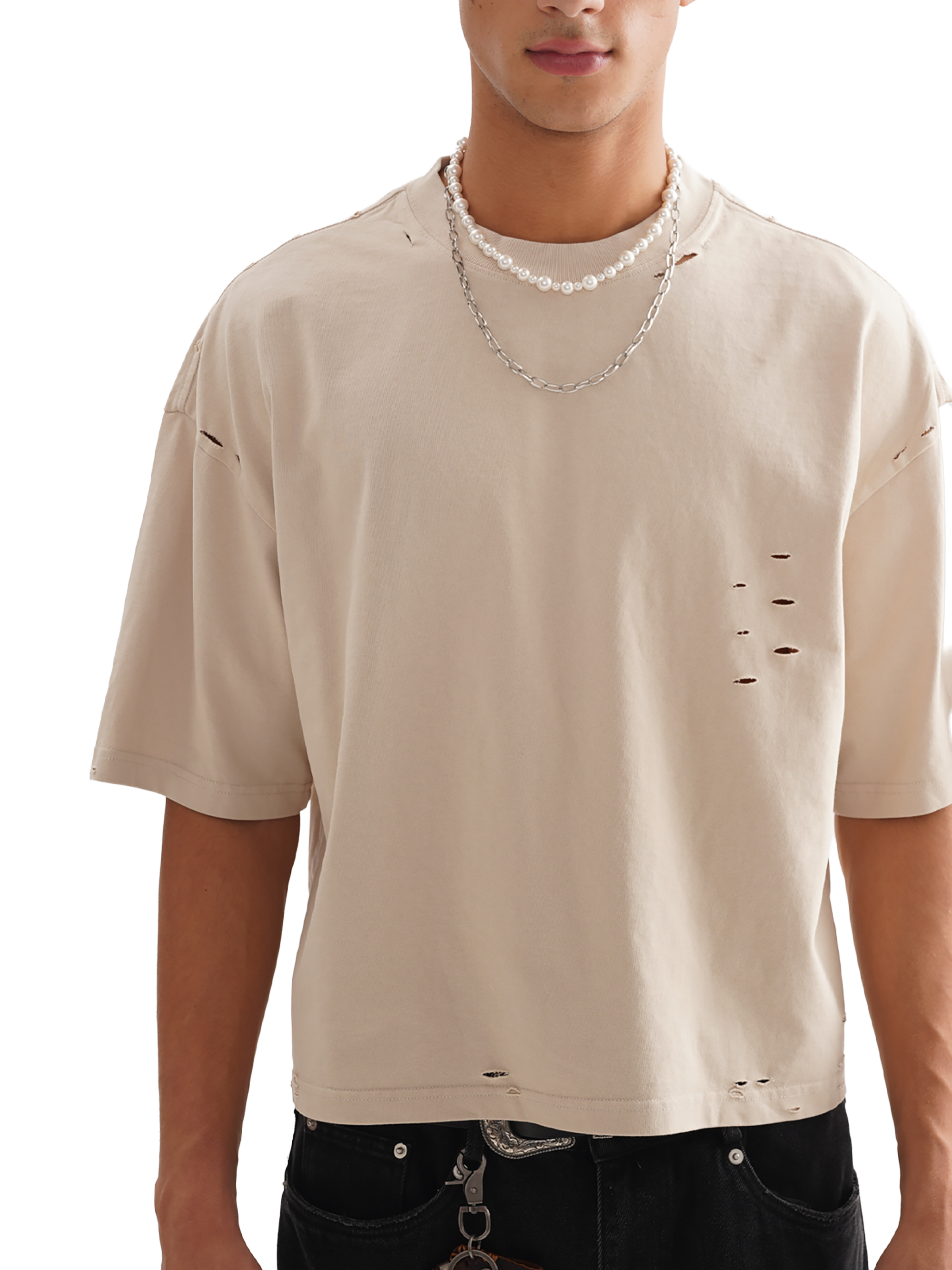 Genzerz cream distressed oversized tee on model with minimal front detail and light tears near collar — clean, chill streetwear style.