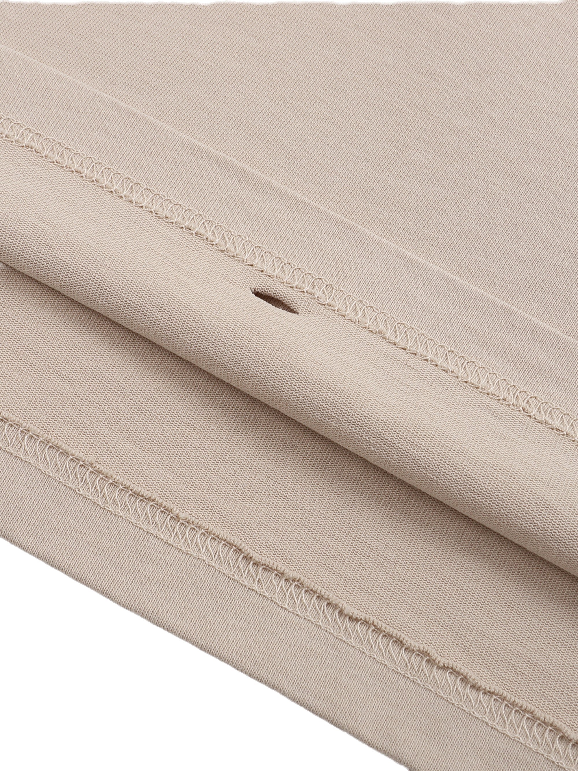 Detailed fabric close-up of Genzerz distressed essential tee, showing luxury cotton weave and soft neutral beige tone for streetwear appeal.