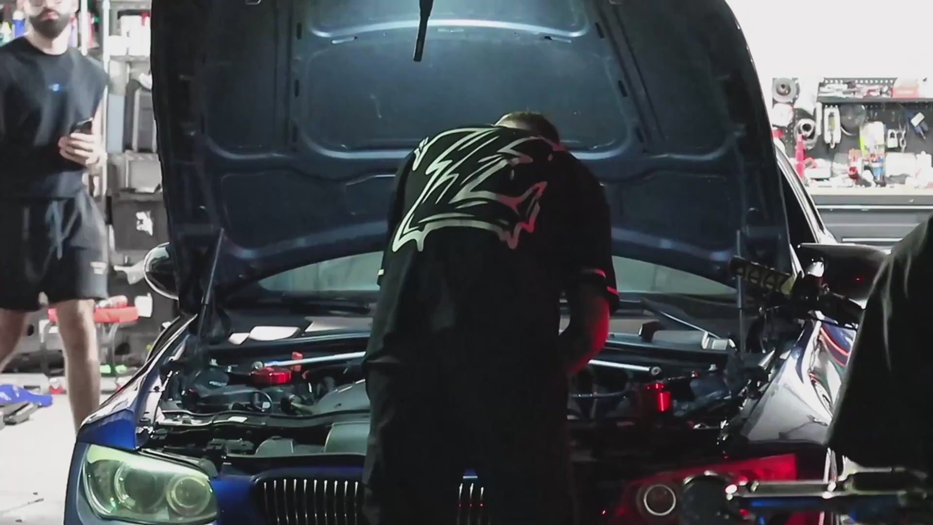 GenZ friends in Genzerz streetwear drive a BMW M4, followed by a Sur-Ron rider wearing a Genzerz Z shirt at shop— cinematic lifestyle clip.